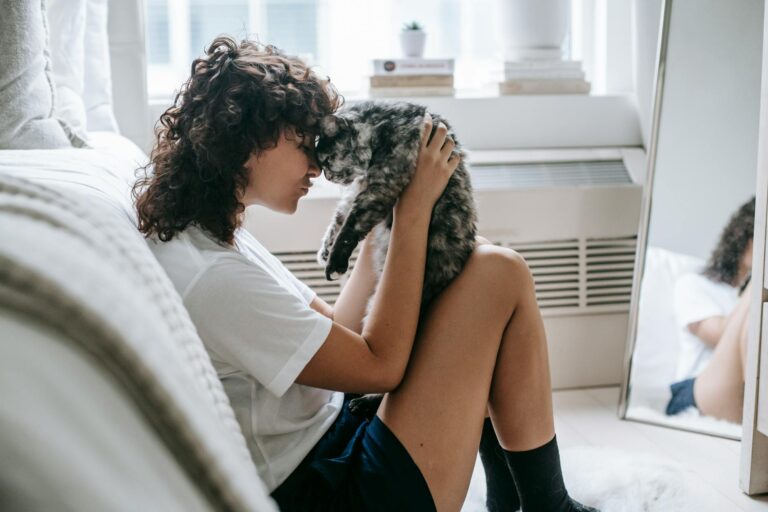 woman touching noses with cat
